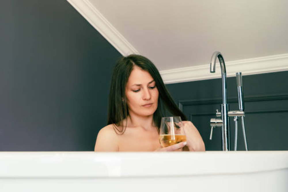woman drinking whisky for hair growth and hair care
